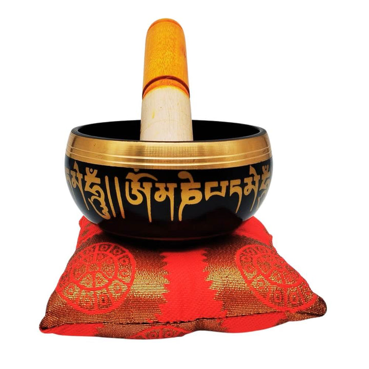 Buddhist singing bowl with red cushion and striker, front view